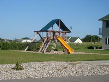 A playground with a swing set and a slide